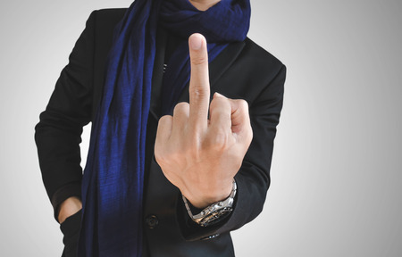 Businessman in casual suit showing middle fingerの写真素材
