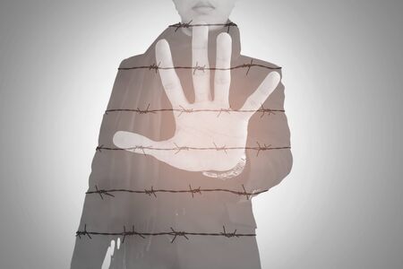 Double exposure, businessman show palm with barbed wire, abstract conceptの写真素材