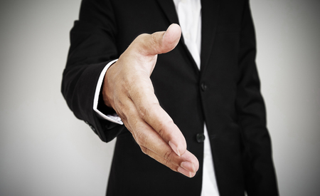 Businessman extending hand, selective focus, shallow depth of fieldの写真素材