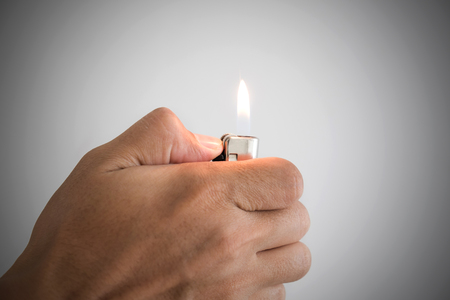 a man hand and with lighterの写真素材