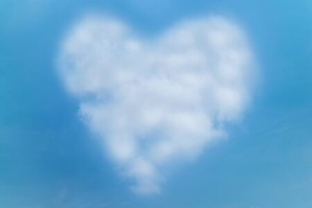 Heart shape cloud on blue skyの写真素材