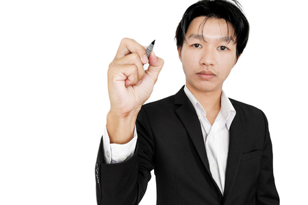 Asian guy in black suit drawing on screen, selective focus, isolated on white backgroundの写真素材