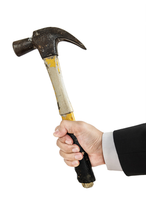 Businessman hand holding old hammer, isolated on white backgroundの写真素材
