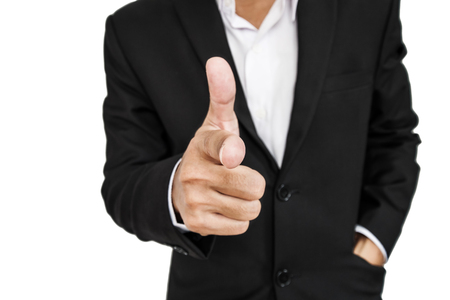 Businessman in black suit pointing hand gun sign to screen, selective focus, isolated on white backgroundの写真素材