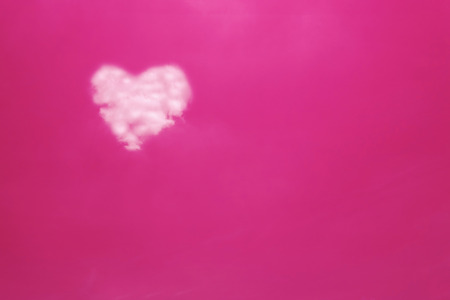 Heart shape cloud on pink skyの写真素材