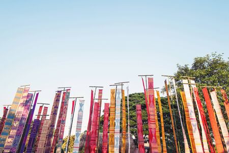 Colorful Lanna flag Thai style at Chinag Mai, Thailand with copy space on blue skyの写真素材