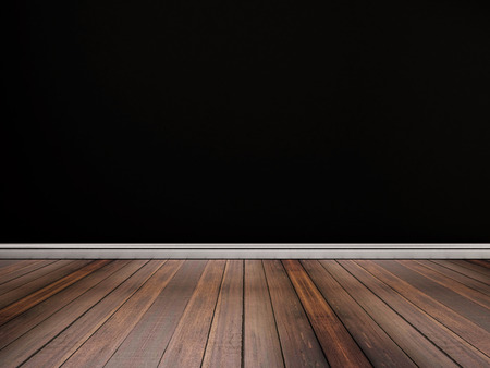 Hardwood floor with black wallの写真素材