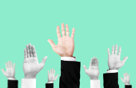 Hand raising upward with unique colored one, on pastel vintage tone background , abstract concept and ideasの写真素材
