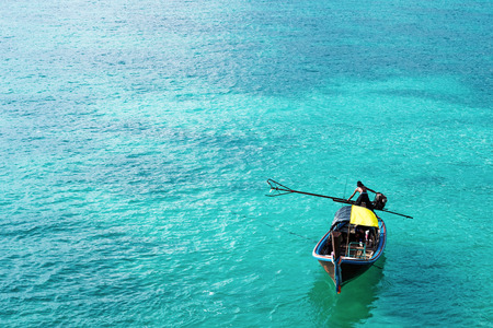 Wooden boat on beautiful ocean in Lipe island, Thailandの写真素材