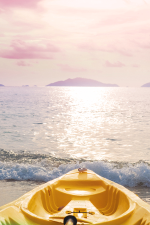 Kayak prow on tropical beach in sunset, pastel vintage toneの写真素材