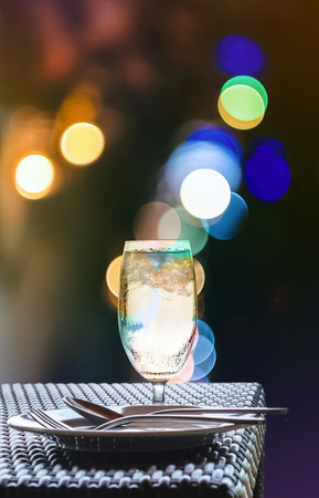 Glass of cold water with nightlife Bokeh lighting backgroundの写真素材