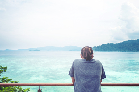 a girl looking to blue ocean, vintage toneの写真素材