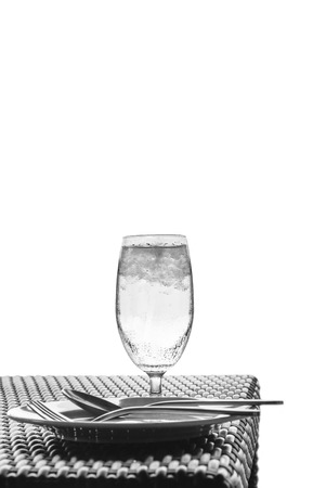 Glass of cold water on dining table, isolated on white backgroundの写真素材