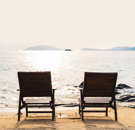 Couple chairs on the beach in sunset, holiday vacation summer time conceptの写真素材