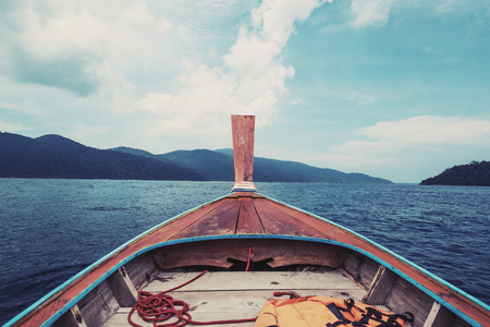 Boat floating on tropical ocean in thailand, vintage toneの写真素材