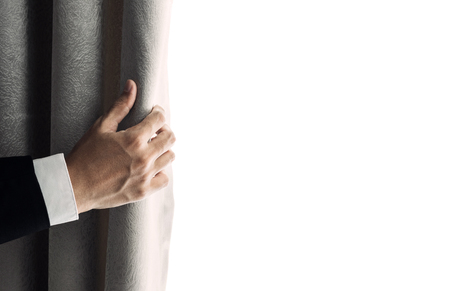 Businessman hand opening curtain, receiving bright light in the morning. with copy spaceの写真素材