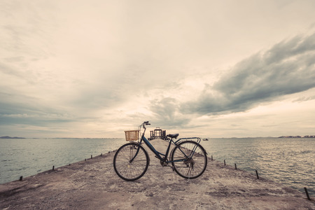 Vintage bicycle on concrete pier, vintage tone, soft focusの写真素材