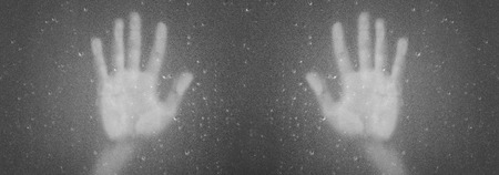 Palm hands behind frosted glass with droplets, black and whiteの写真素材