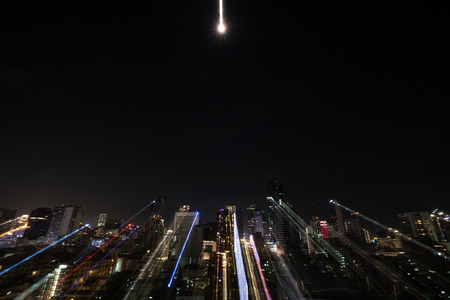 Abstract motion lines with defocus city with moon shine at nightの写真素材