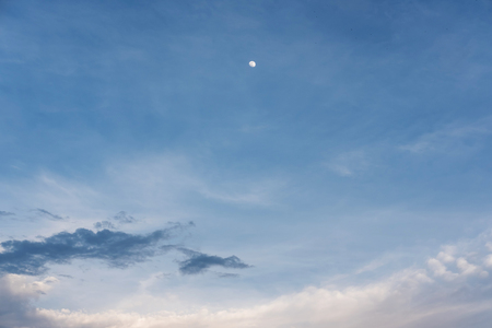Blue sky and white clouds and moon at duskの写真素材