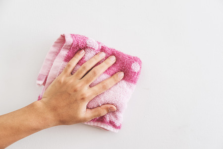 Hand cleaning white wallの写真素材