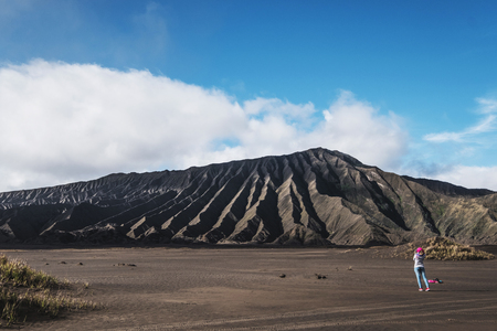 Landscape of Mount Bromo, Indonesia with tourist womanの写真素材