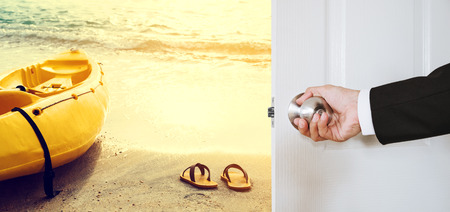 Businessman hand holding door knob, opening to the beach with yellow kayak and flip flop, vintage tone, business summer vacation conceptの写真素材
