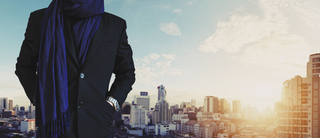 Businessman hand in pocket, in casual suit with Bangkok city view in sunriseの写真素材