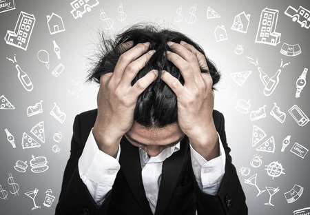 Businessman stressed out, with expense doodle icon - bankruptcy debtの写真素材