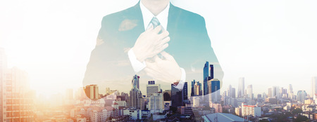 Double exposure businessman and panoramic view of Bangkok city in sunrise