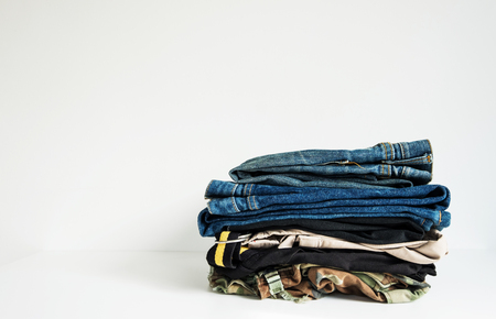 Denim Jeans with Clothing Stacked, isolated on white background