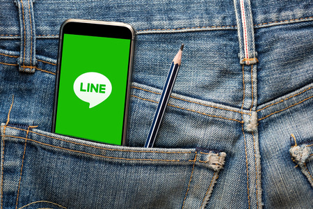THAILAND - 13 JUL - Smartphone opening social media Line Application on screen, in jenim jean pocket with pencil on July 13, 2016のeditorial素材