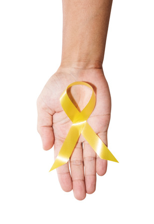 Aids Awareness. male hand holding yellow AIDS awareness ribbon, isolated on white backgroundの写真素材