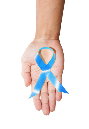 Aids Awareness. male hand holding blue AIDS awareness ribbon, isolated on white backgroundの写真素材