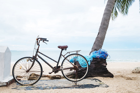 Old rusty bicycle parking at the beachの写真素材