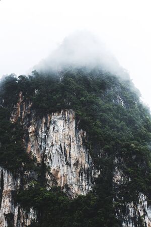 Mountain peak with clouds in winterの写真素材