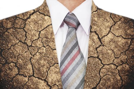 Double exposure, close-up businessman with cracked arid soil ground textureの写真素材