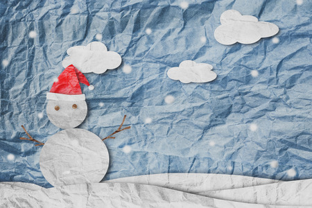 Christmas Background, Snowman wearing red Santa hat in winter with white clouds snow, paper cut made of crumpled paperの写真素材