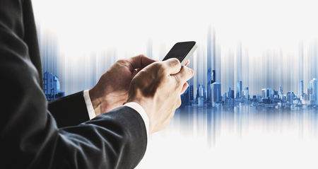 Businessman using smartphone with city, business communication technology conceptsの写真素材