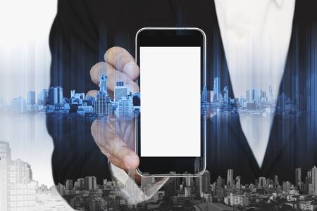 Businessman holding smartphone with with blank copy space on screen, business communication technology conceptsの写真素材