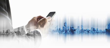 Businessman using smartphone with city, business communication technology conceptsの写真素材