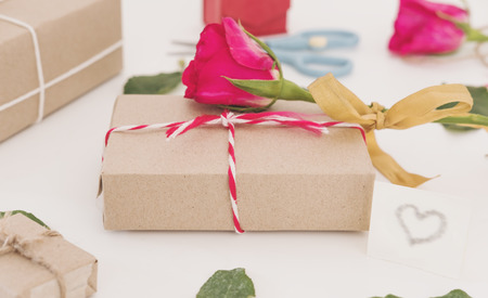 Valentines Day preparation gift, gift box with roses on white tableの写真素材