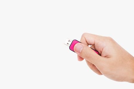 Close-up Hand holding USB data storage flash drive, isolated on white backgroundの写真素材