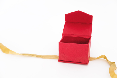 Red box opened with bolden ribbon, isolated on white backgroundの写真素材
