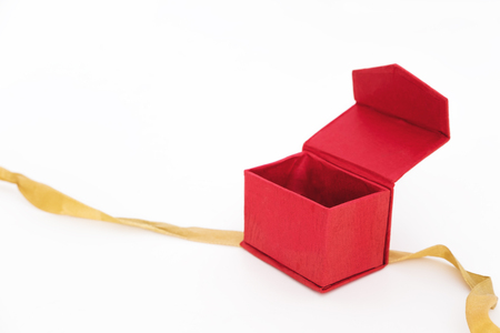 Red box opened with bolden ribbon, isolated on white backgroundの写真素材
