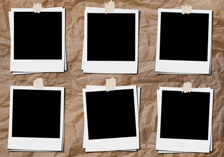 Blank classic film photo frame with tapes, on crumpled paper boardの写真素材