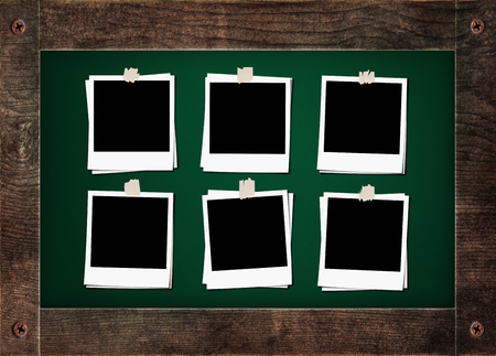 Blank classic film photo frame with tapes, on green board with wooden frameの写真素材