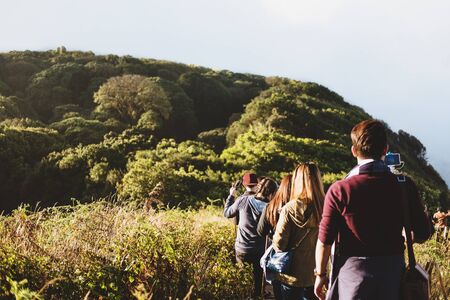 Group of people walking on mountain in morning sunrise, trekking on the Kew Mae Parn, National Park mountainの写真素材