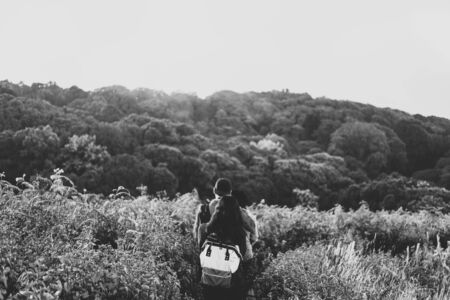 People walking in grassland on the mountain, Kew Mae Parn national park, Chiang Mai Thailandの写真素材