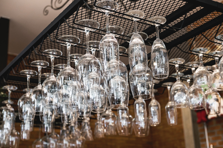 Wine glass hanging oh shelf in pub & restaurantの写真素材